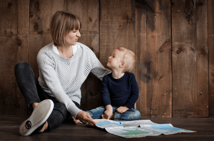 mom and son looking at a map